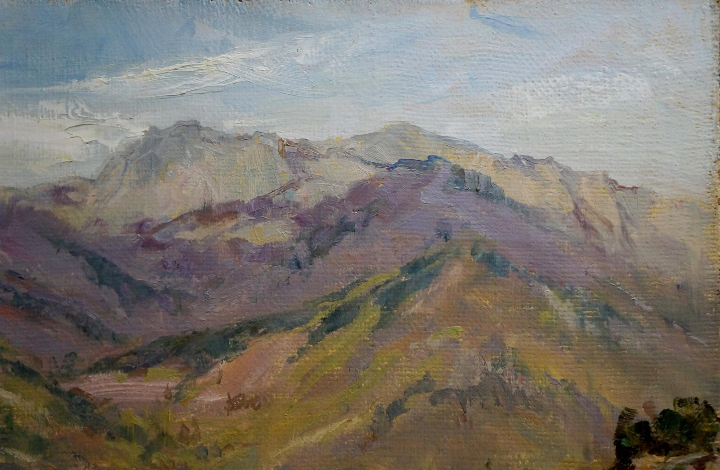 City among mountains portrayed in an oil painting by an unknown artist